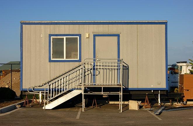 a row of mobile office units at a job site